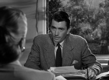 Movie still from “Gentleman's Agreement” (1947), directed by Elia Kazan – A man sitting at a table in front of a woman; Medium shot, Over the shoulder angle