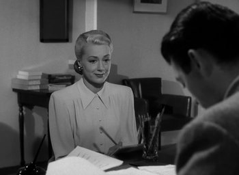Movie still from “Gentleman's Agreement” (1947), directed by Elia Kazan – A woman sitting at a table in front of a man; Medium shot, Over the shoulder angle