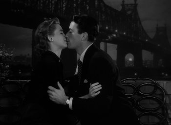 Movie still from “Gentleman's Agreement” (1947), directed by Elia Kazan – A man and a woman kissing on a bench; Medium shot, Low angle