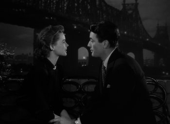 Movie still from “Gentleman's Agreement” (1947), directed by Elia Kazan – A man and a woman sitting next to each other on a bench; Medium shot, Low angle