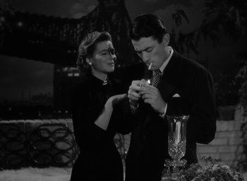 Movie still from “Gentleman's Agreement” (1947), directed by Elia Kazan – A man and a woman looking at a cell phone; Medium shot, High angle
