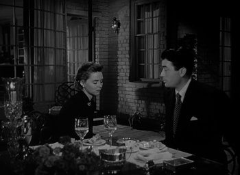 Movie still from “Gentleman's Agreement” (1947), directed by Elia Kazan – A man and a woman sitting at a dinner table; Medium shot, High angle