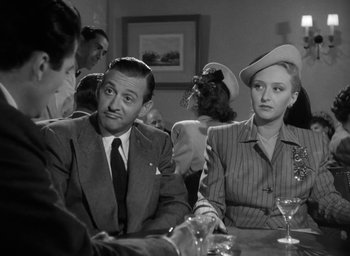 Movie still from “Gentleman's Agreement” (1947), directed by Elia Kazan – A man and a woman sitting at a table; Medium shot, Over the shoulder angle
