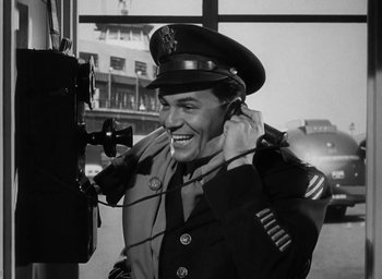 Movie still from “Gentleman's Agreement” (1947), directed by Elia Kazan – An old photo of a man in a military uniform; Medium shot, Low angle