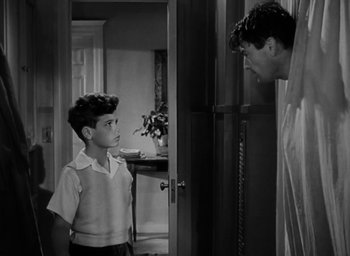 Movie still from “Gentleman's Agreement” (1947), directed by Elia Kazan – A young boy standing in front of an older man; Medium shot, Over the shoulder angle