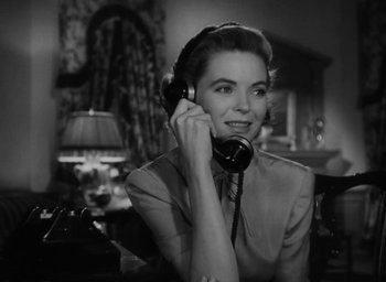 Movie still from “Gentleman's Agreement” (1947), directed by Elia Kazan – A woman talking on a phone while sitting at a table; Close Up shot, Low angle