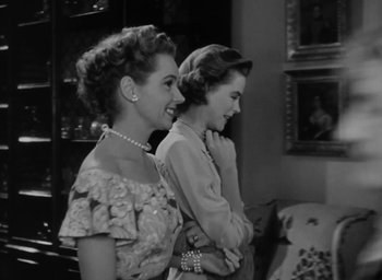Movie still from “Gentleman's Agreement” (1947), directed by Elia Kazan – A couple of women standing next to each other in a room; Medium shot, Low angle