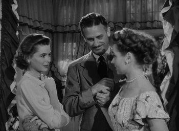 Movie still from “Gentleman's Agreement” (1947), directed by Elia Kazan – A man and two women are standing together; Medium shot, Over the shoulder angle