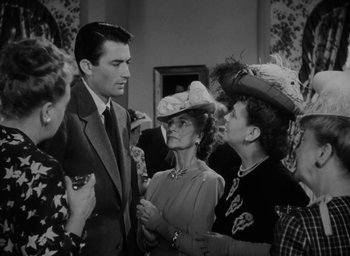 Movie still from “Gentleman's Agreement” (1947), directed by Elia Kazan – A man and two women are talking to each other; Medium shot, Over the shoulder angle