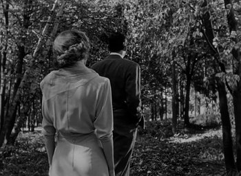 Movie still from “Gentleman's Agreement” (1947), directed by Elia Kazan – A man and a woman walking through the woods; Medium shot, Low angle