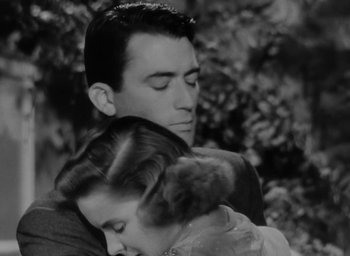 Movie still from “Gentleman's Agreement” (1947), directed by Elia Kazan – A black and white photo of a man and a woman hugging; Close Up shot, High angle