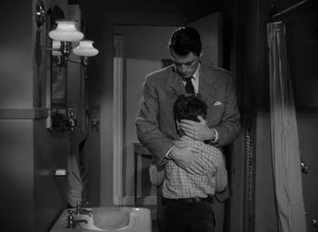Movie still from “Gentleman's Agreement” (1947), directed by Elia Kazan – A man is holding a young boy in his arms; Medium shot, High angle