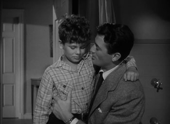 Movie still from “Gentleman's Agreement” (1947), directed by Elia Kazan – A man and a young boy standing next to each other; Medium shot, Over the shoulder angle