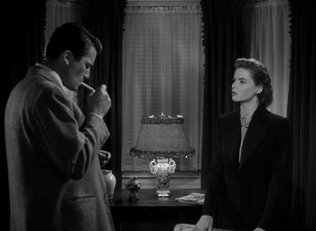 Movie still from “Gentleman's Agreement” (1947), directed by Elia Kazan – A man and a woman are standing in front of a lamp; Medium shot, Low angle