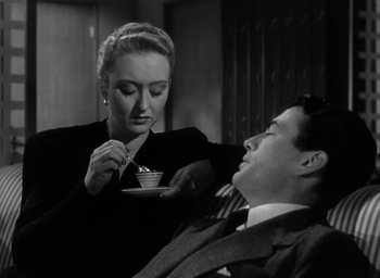 Movie still from “Gentleman's Agreement” (1947), directed by Elia Kazan – A woman is feeding a man a cup of coffee; Medium shot, High angle