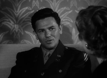 Movie still from “Gentleman's Agreement” (1947), directed by Elia Kazan – An old photo of a man in a military uniform; Close Up shot, Over the shoulder angle