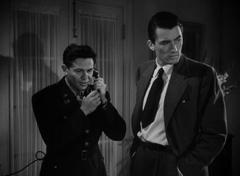 Movie still from “Gentleman's Agreement” (1947), directed by Elia Kazan – Two men in suits and ties are looking at each other; Medium shot, Low angle
