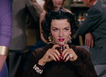 Movie still from “Gentlemen Prefer Blondes” (1953), directed by Howard Hawks – A woman holding a drink in her hands; Close Up shot, High angle