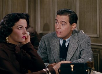 Movie still from “Gentlemen Prefer Blondes” (1953), directed by Howard Hawks – A man and a woman sitting at a table; Medium shot, Over the shoulder angle