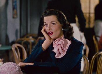 Movie still from “Gentlemen Prefer Blondes” (1953), directed by Howard Hawks – A woman sitting at a table in a restaurant; Close Up shot, High angle