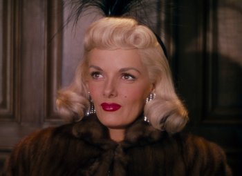 Movie still from “Gentlemen Prefer Blondes” (1953), directed by Howard Hawks – A woman in a fur coat with a feather in her hair; Close Up shot, Over the shoulder angle