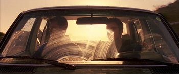 Movie still from “Gerry” (2002), directed by Gus Van Sant – A man sitting in the back seat of a car; Medium shot, Low angle