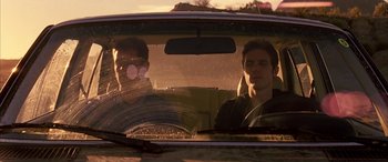 Movie still from “Gerry” (2002), directed by Gus Van Sant – Two young men in the back seat of a car; Medium shot, Low angle