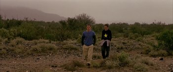 Movie still from “Gerry” (2002), directed by Gus Van Sant – A man and a woman are walking through the desert; Medium shot, Low angle
