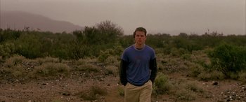 Movie still from “Gerry” (2002), directed by Gus Van Sant – A man standing in the middle of a field; Medium shot, Low angle