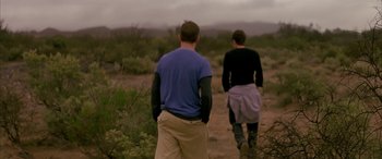 Movie still from “Gerry” (2002), directed by Gus Van Sant – A man and a woman are walking through the desert; Medium shot, Over the shoulder angle