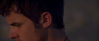 Movie still from “Gerry” (2002), directed by Gus Van Sant – A man's ear is shown in a blurry photo; Extreme Close Up shot, Over the shoulder angle