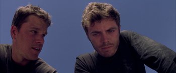 Movie still from “Gerry” (2002), directed by Gus Van Sant – A person wearing a black shirt; Close Up shot, Low angle