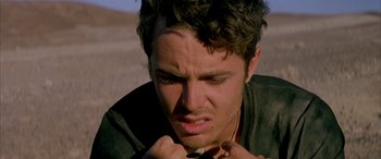 Movie still from “Gerry” (2002), directed by Gus Van Sant – A person with his hand on his chin; Close Up shot, Low angle