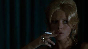 Movie still from “Get Carter” (1971), directed by Mike Hodges – A beautiful woman smoking a cigarette in front of a mirror; Close Up shot, Over the shoulder angle