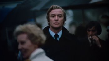 Movie still from “Get Carter” (1971), directed by Mike Hodges – A person wearing a suit and tie; Close Up shot, Low angle