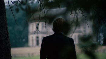 Movie still from “Get Carter” (1971), directed by Mike Hodges – A man standing in front of a house in the dark; Medium shot, Low angle