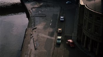 Movie still from “Get Carter” (1971), directed by Mike Hodges – Cars are parked on the side of a road; Extreme Wide shot, High angle