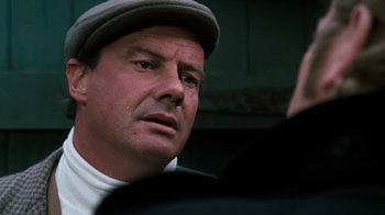 Movie still from “Get Carter” (1971), directed by Mike Hodges – A person wearing a hat; Close Up shot, Over the shoulder angle