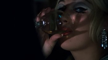 Movie still from “Get Carter” (1971), directed by Mike Hodges – A person holding a glass of wine; Extreme Close Up shot, Over the shoulder angle