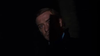 Movie still from “Get Carter” (1971), directed by Mike Hodges – A person in a dark room; Close Up shot, Low angle