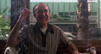 Movie still from “Get Shorty” (1995), directed by Barry Sonnenfeld – An older man sitting in front of a window; Medium shot, Low angle