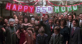 Movie still from “Get Shorty” (1995), directed by Barry Sonnenfeld – A large group of people in a room with confetti on their heads; Wide shot, High angle