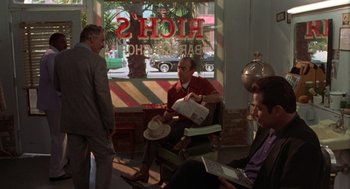 Movie still from “Get Shorty” (1995), directed by Barry Sonnenfeld – A group of people sitting in a room; Wide shot, Over the shoulder angle