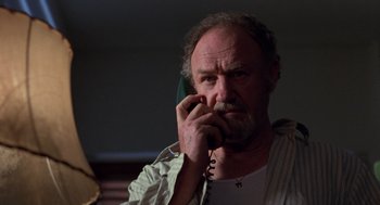 Movie still from “Get Shorty” (1995), directed by Barry Sonnenfeld – An older man talking on a phone in a room; Close Up shot, Low angle
