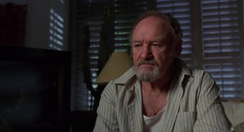 Movie still from “Get Shorty” (1995), directed by Barry Sonnenfeld – An older man sitting in a chair in front of a window; Close Up shot, Low angle