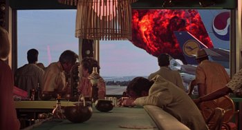 Movie still from “Get Shorty” (1995), directed by Barry Sonnenfeld – A group of people sitting around a table; Extreme Wide shot, Over the shoulder angle