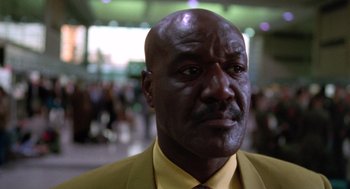 Movie still from “Get Shorty” (1995), directed by Barry Sonnenfeld – A person wearing a suit and tie; Close Up shot, Low angle