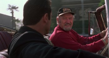 Movie still from “Get Shorty” (1995), directed by Barry Sonnenfeld – Two men sitting in a car and one of them is wearing a hat; Close Up shot, Over the shoulder angle