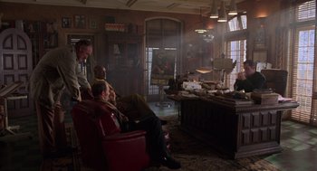 Movie still from “Get Shorty” (1995), directed by Barry Sonnenfeld – A group of people sitting in a room; Wide shot, Over the shoulder angle