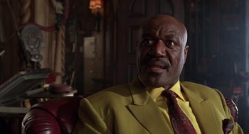 Movie still from “Get Shorty” (1995), directed by Barry Sonnenfeld – A man in a yellow suit and a red neck tie; Close Up shot, Low angle